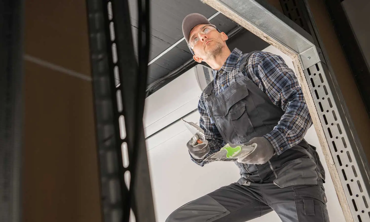 A professional technician installing a garage door, demonstrating the expertise of a garage door marketing agency.