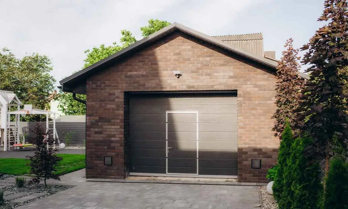 A sleek, contemporary garage door with a pedestrian entry, illustrating the premium designs showcased by a garage door marketing agency