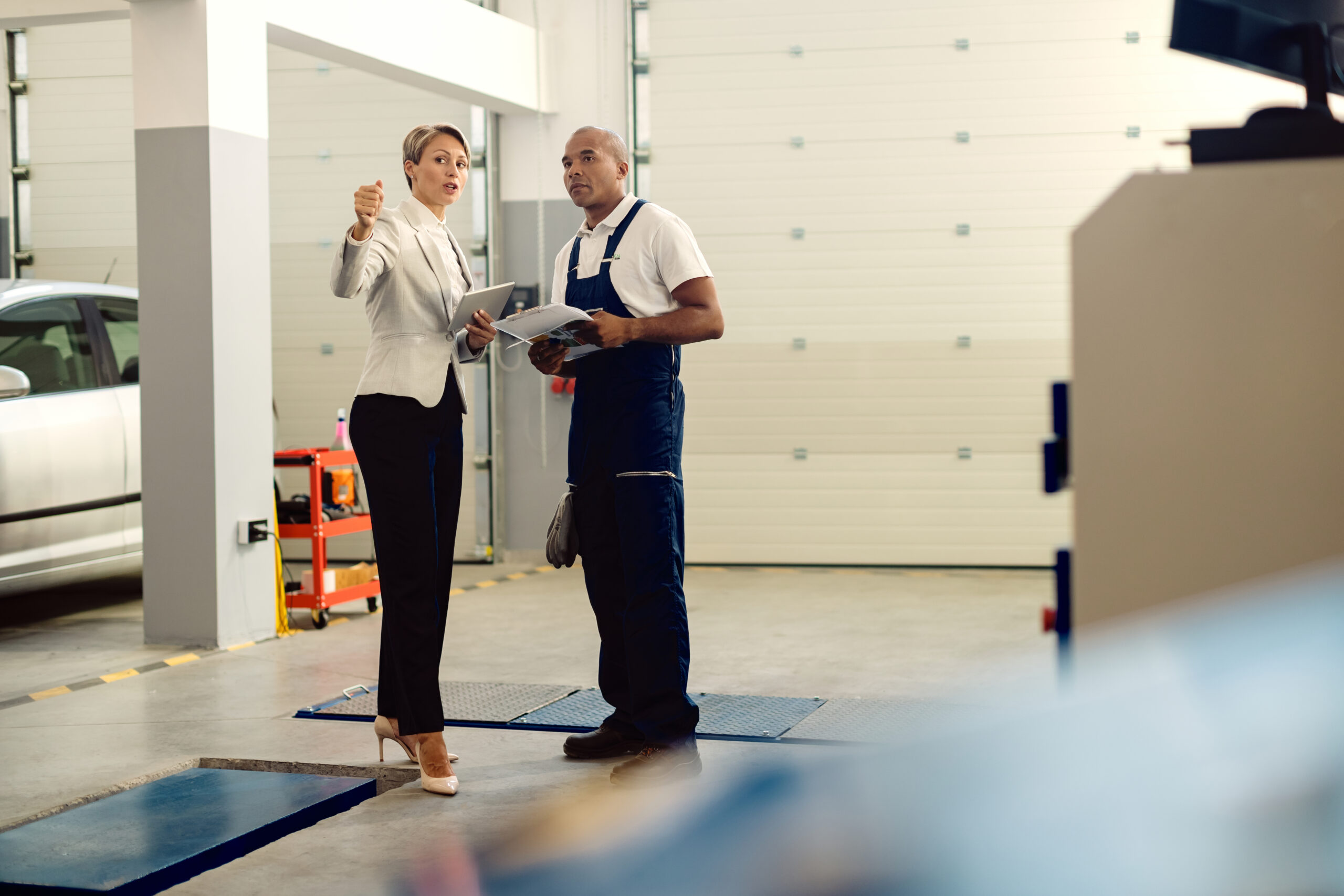 Business owner and technician discussing service strategy — a hands-on example of Garage Door Marketing Ideas in action