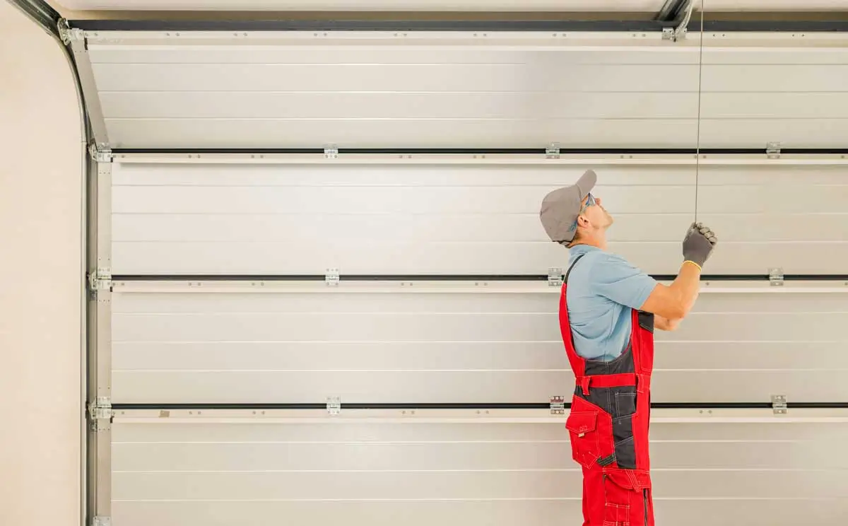 Garage Door Repair Digital Marketing Services 2 Garage door repair technician adjusting overhead cables with garage door repair digital marketing services helping drive new bookings