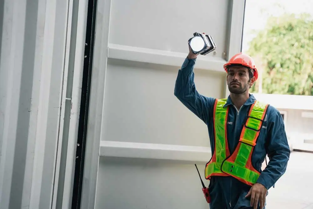 Garage Door Repair Ppc Company 3 Garage contractor assessing commercial door hardware for a garage door repair ppc company project